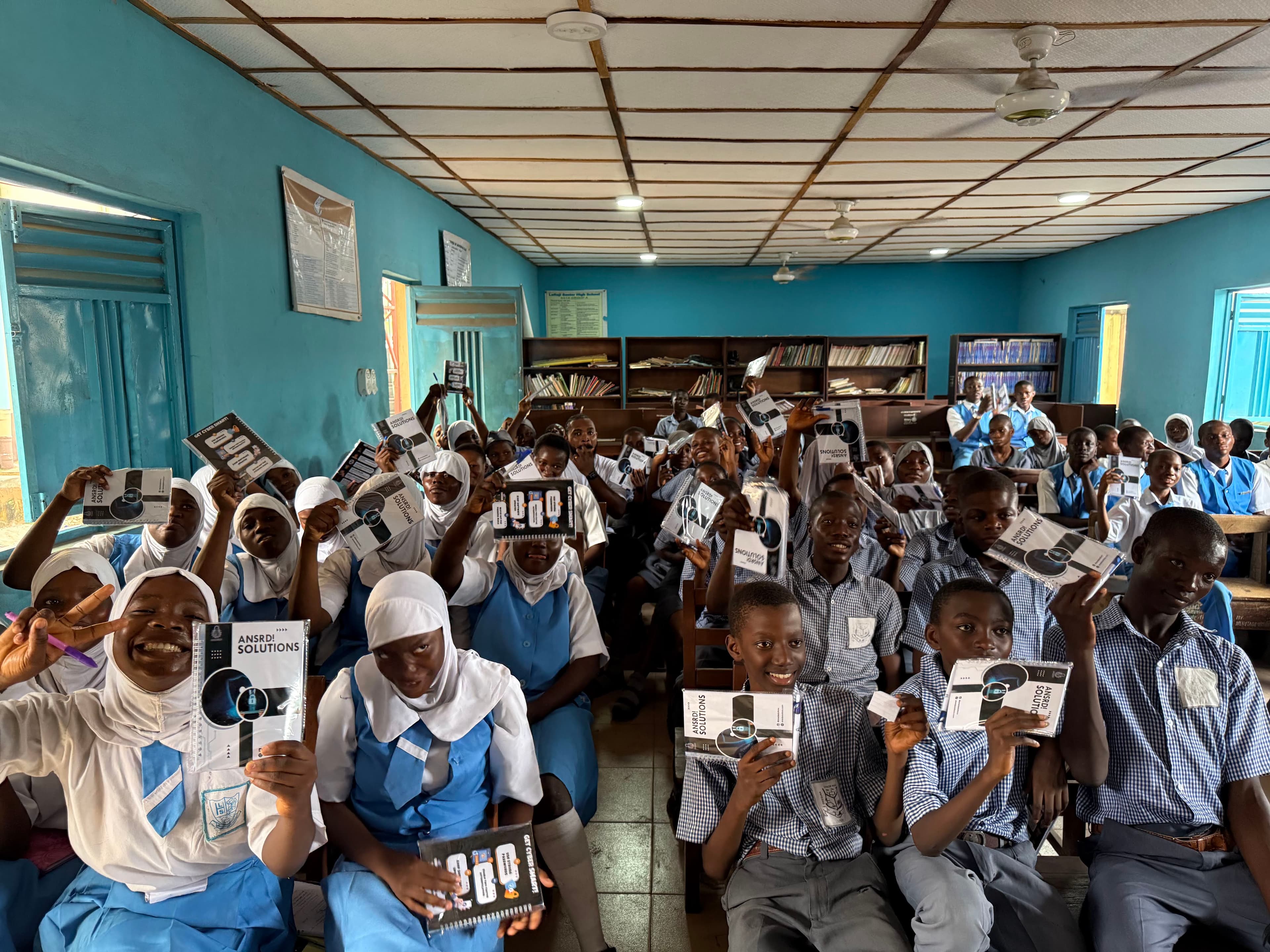 Students with ANSRD cybersecurity workbooks — reinforcing learned behaviours with take-home materials