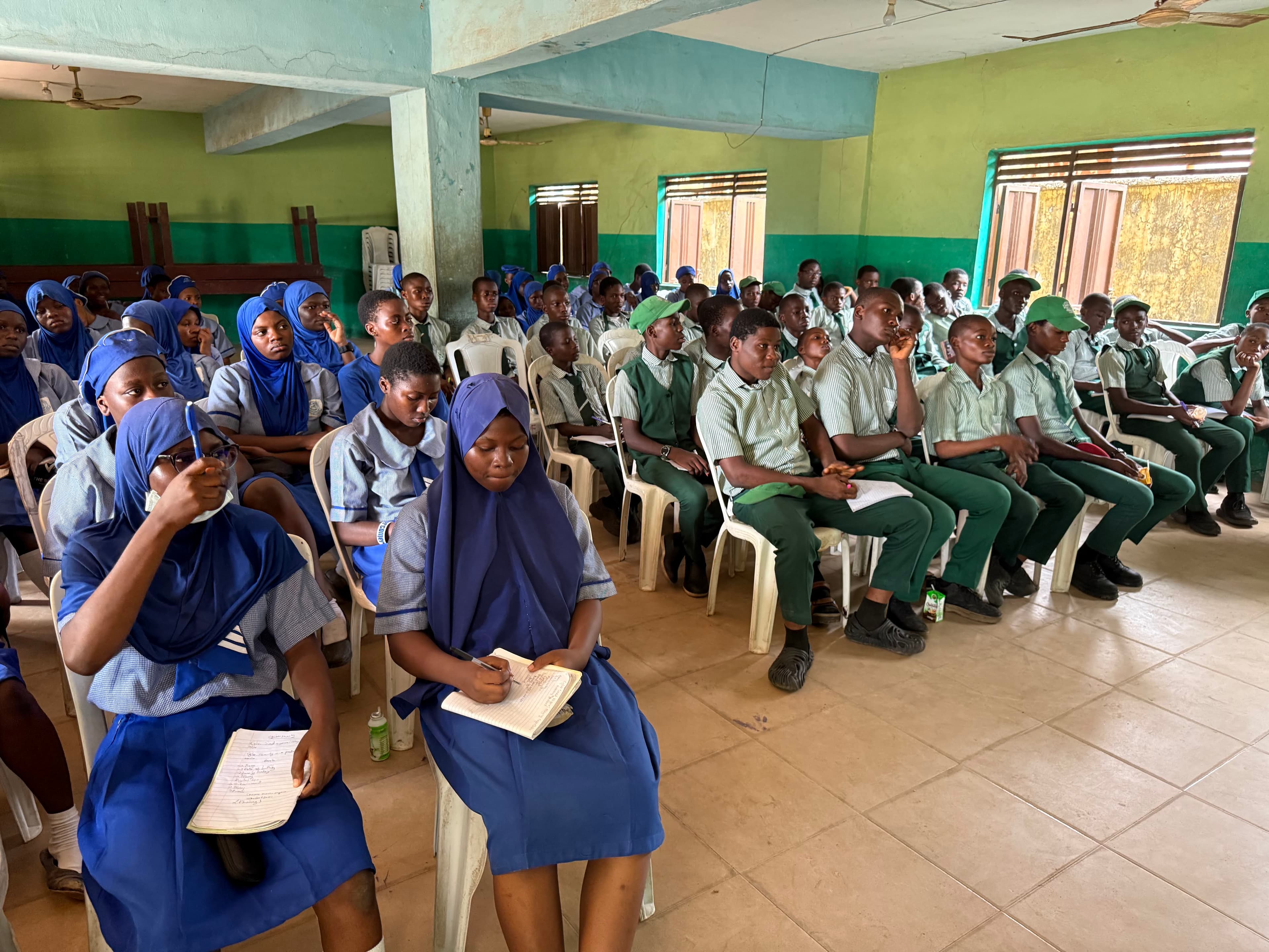 Students actively taking notes — converting awareness into personal commitments